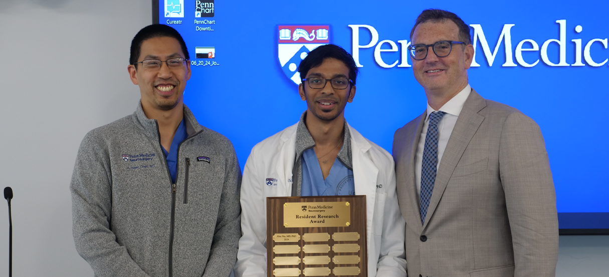 Dr. Chen and Dr. Yoshor presenting resident Alex Vaz with a research award.