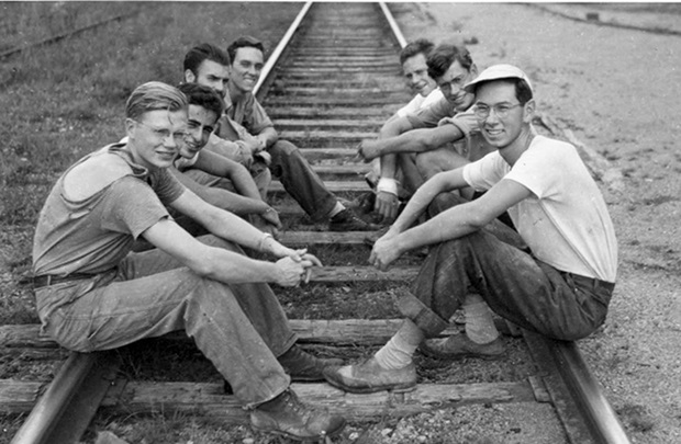 men on railroad tracks