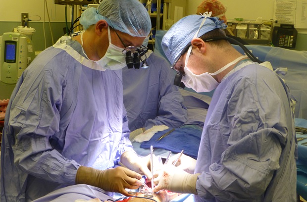 Dr. Levin in surgery with microscope