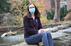 Jennifer Orthmann-Murphy sitting by pond with mask