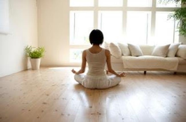 Woman practicing yoga in living room