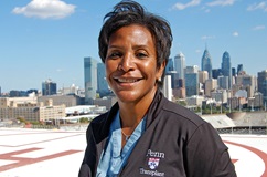 Georgeine Smith Transplant Physician Assistant smiling at camera on helipad 