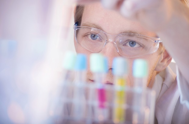 Scientist staring at vials