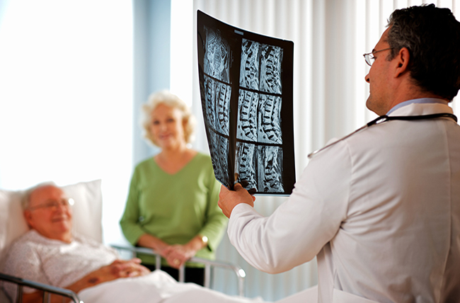 https://www.pennmedicine.org/-/media/images/medical%20and%20research%20images/radiology%20images/doctor_looking_at_spine_xray_patient.ashx