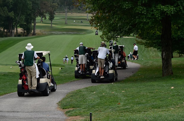 Golfers and golf carts on a golf course