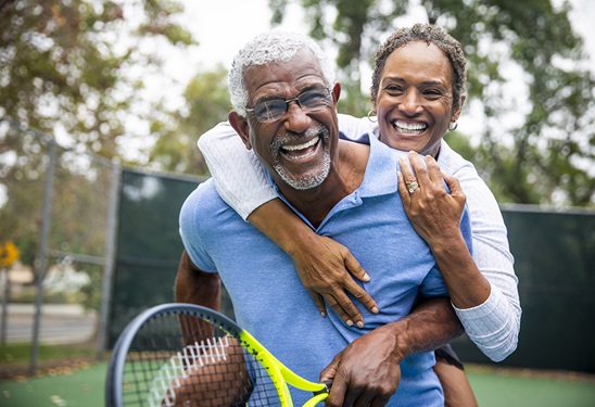Older Man and Woman Tennis Laughing