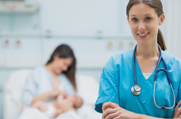 provider standing in the forefront with a woman breast feeding in the background