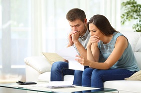 a man and woman stressing over finances