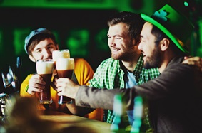 guys wearing saint Patrick's day clothes while drinking beer