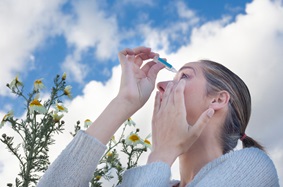 woman using eye drops