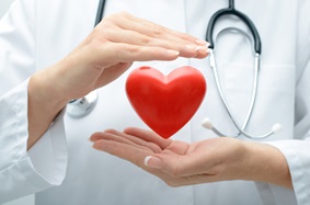 heart floating between doctor's hands