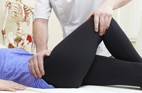Doctor treating hip pain