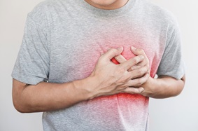 Man holding chest in pain