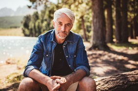 man sitting in the woods