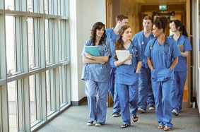 group of medical students walking down a hallway