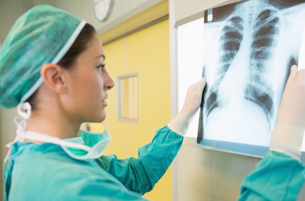 female provider holding up a lung xray