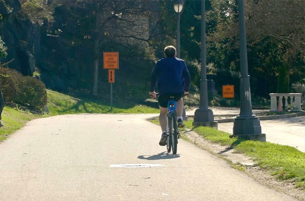 Man riding bicycle down road