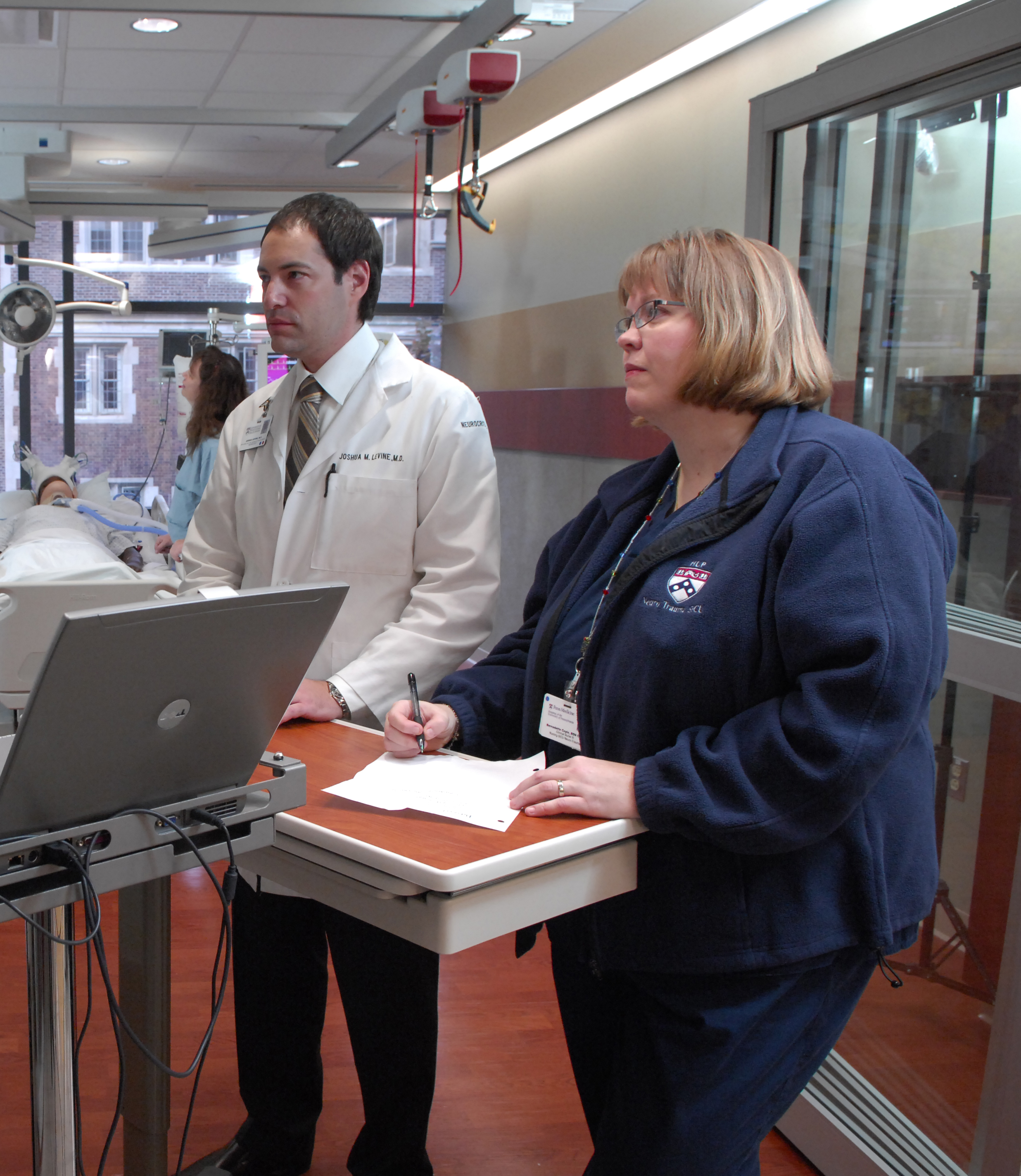 two people working at standing desks