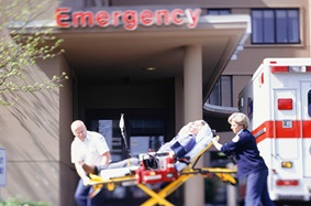 EMTs pushing a person on a stretcher