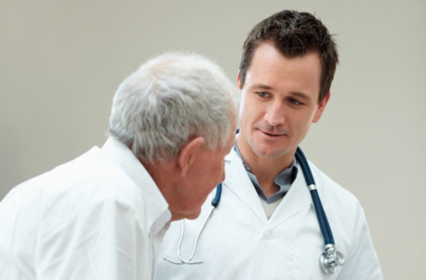 Male doctor with elderly male patient