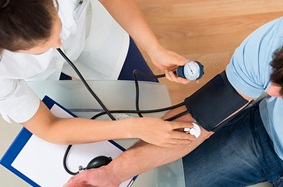 nurse taking a patient's blood pressure