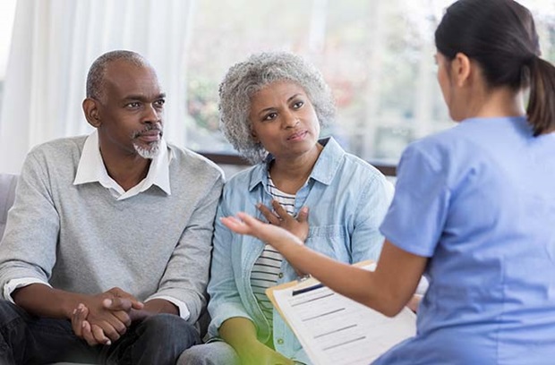 Older couple talking to provider
