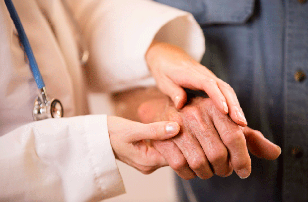 Provider holding a patient's hand