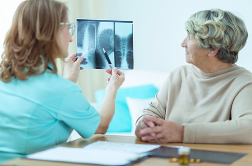 provider showing an xray to a woman
