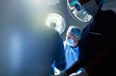 A close-up of three surgeons in the operating room
