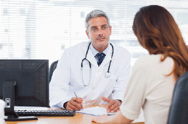 Doctor at desk talking to patient