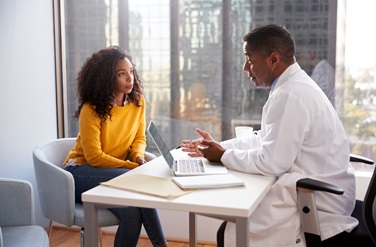 Male doctor discusses plan with female patient