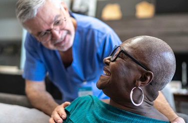 Nurse smiling at patient in home