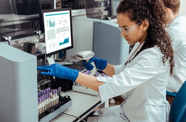 Woman in lab scanning vials
